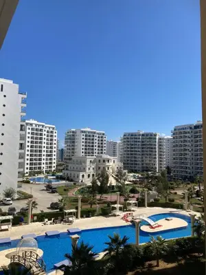 a view of a city with two pools and buildings at Апартаменты Студия in Dherinia
