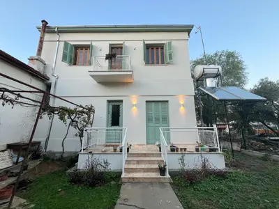a white house with stairs leading up to it at 1947 Rescued Stone House in Nicosia