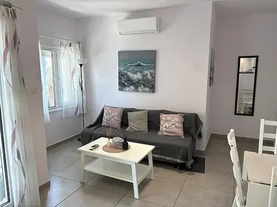 a living room with a couch and a table at Cozy beachfront gem with seaview in Limassol