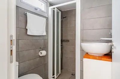 a bathroom with a toilet and a sink at Cozy beachfront gem with seaview in Limassol