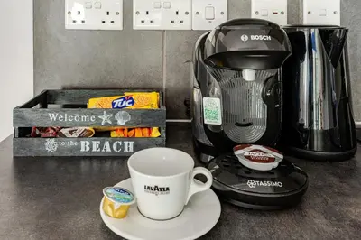 a coffee maker and a coffee cup on a counter at Cozy beachfront gem with seaview in Limassol
