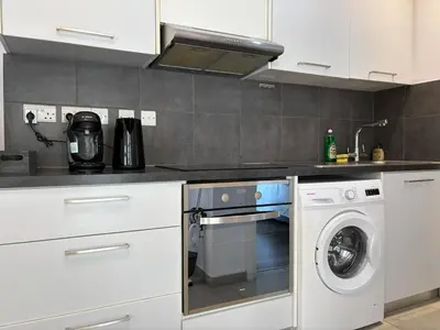 a kitchen with a dishwasher and a washer at Cozy beachfront gem with seaview in Limassol