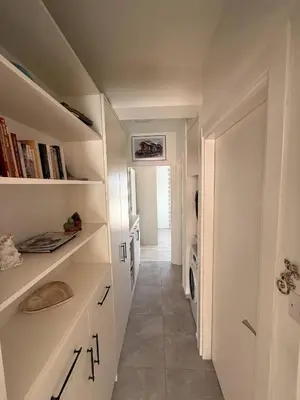 a hallway with white cabinets and a washer and dryer at Central Nicosia Haven in Nicosia