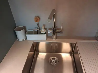 a kitchen sink with a faucet on top of it at Lazuli Sea View & Pool Ap 502 in Larnaka