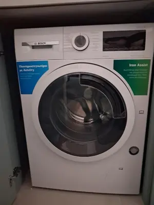 a white washing machine sitting in a room at Lazuli Sea View & Pool Ap 502 in Larnaka