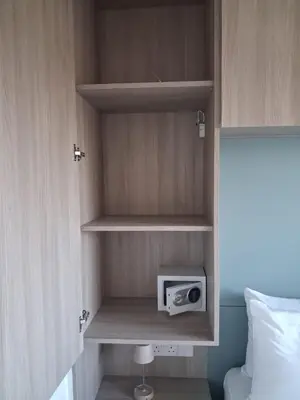 a small cabinet with a radio in a bedroom at Lazuli Sea View & Pool Ap 502 in Larnaka