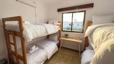 a room with two bunk beds and a window at SundyBeach Beachfront 2Bdr Dhekelia in Larnaka
