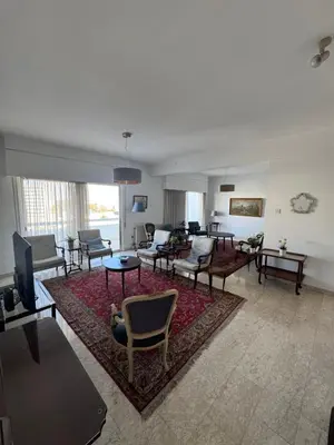 a living room with couches and chairs on a rug at Ellados in Strovolos