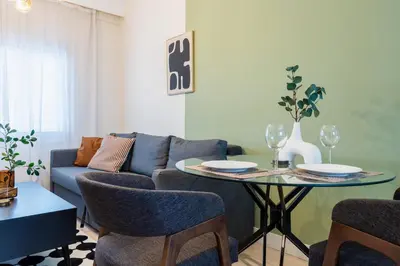 a living room with a couch and a table with chairs at Local Host Living - Signature Apartments in Nicosia in Nicosia