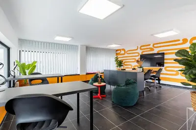 an office with desks and chairs and plants at Local Host Living - Signature Apartments in Nicosia in Nicosia