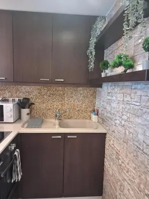 a kitchen with a sink and a brick wall at Lazuli Sea View Beachfront Studio Nr 305 in Larnaka