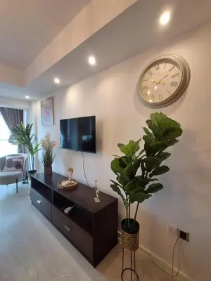 a living room with a large clock on the wall at Lazuli Sea View Beachfront Studio Nr 305 in Larnaka
