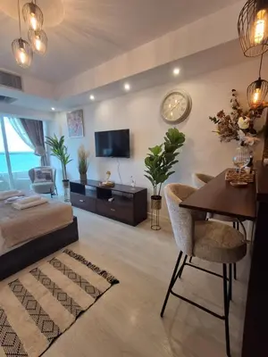 a living room with a bed and a dining room at Lazuli Sea View Beachfront Studio Nr 305 in Larnaka