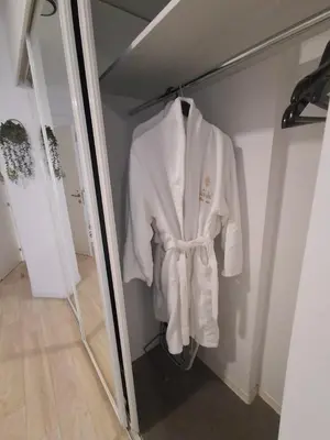 a robe is hanging on a door in a room at Lazuli City Center Studio 161 - 100 m from the beach in Larnaka