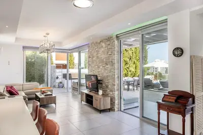 a living room with a couch and a tv at Milos lifestyle H29 in Protaras