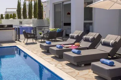 a pool with lounge chairs and a couch and a table at Milos lifestyle H29 in Protaras