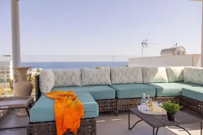 a couch on a balcony with a view of the ocean at Milos lifestyle H29 in Protaras