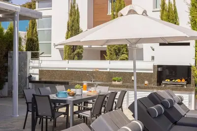 a patio with a table and chairs and an umbrella at Milos lifestyle H29 in Protaras
