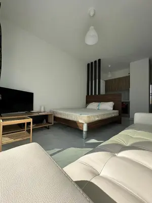 a bedroom with two beds and a flat screen tv at Seaside Studio in Limassol