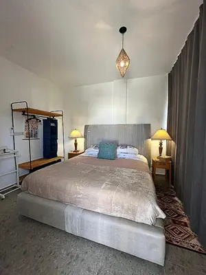 a bedroom with a large bed and two lamps at Nicosia city center 1BDR apartment in Nicosia