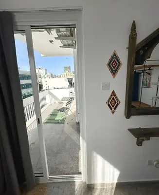 a room with a door open to a balcony at Nicosia city center 1BDR apartment in Nicosia
