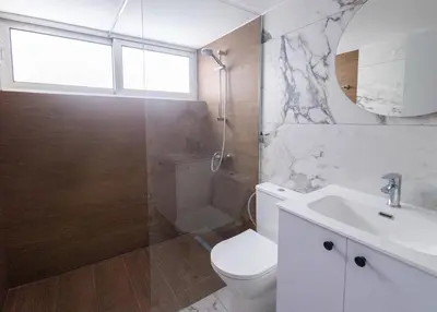 a bathroom with a toilet and a sink and a shower at Maestro Family - Apartment in Larnaka