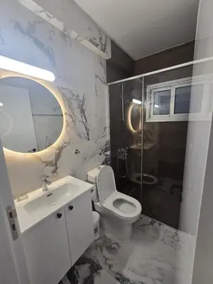 a white bathroom with a sink and a toilet at Maestro Family - Apartment in Larnaka