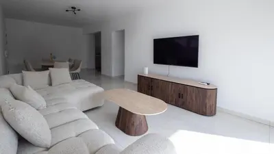 a living room with a couch and a tv at Maestro Family - Apartment in Larnaka