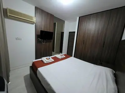 a bedroom with a bed with two towels on it at 5mins from the beach,10mins from LC airport Aurelia Suite in Larnaka