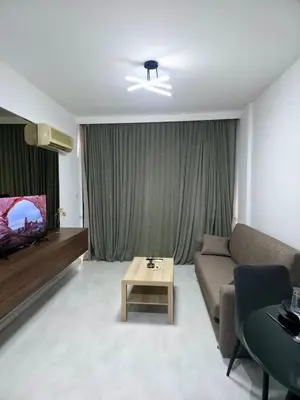 a living room with a couch and a table and a tv at 5mins from the beach,10mins from LC airport Aurelia Suite in Larnaka