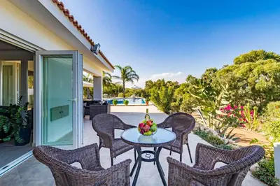 a table with a bowl of fruit on a patio at Marina Heights Villa in Protaras