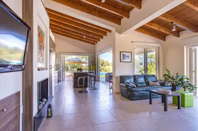 a living room with a couch and a tv at Marina Heights Villa in Protaras