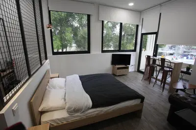 a bedroom with a bed in a room with windows at G.R City Heart in Nicosia