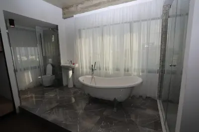 a bathroom with a tub and a toilet and a sink at G.R City Heart in Nicosia