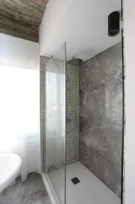 a shower with a glass door in a bathroom at G.R City Heart in Nicosia
