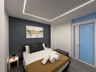 a bedroom with a bed with towels on it at Onar Exclusive Studio Suite in Voroklini