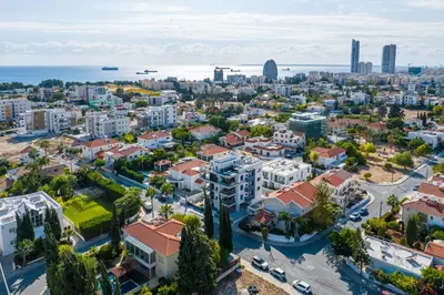 an aerial view of a city with buildings and the ocean at Noir Luxury Residences by Nomads in Limassol