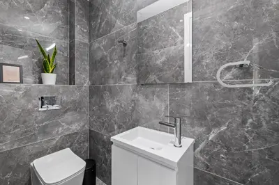 a bathroom with a sink and a toilet at Noir Luxury Residences by Nomads in Limassol