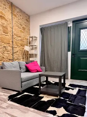 a living room with a couch and a table at Central Nicosia 1BR House in the Walled City in Nicosia