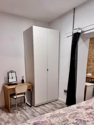 a bedroom with a white cabinet and a desk at Central Nicosia 1BR House in the Walled City in Nicosia