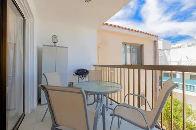 a balcony with a table and chairs in a room at Kapparis Beach Escape in Paralimni