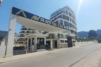 aissana city sign in front of a building at Girne Merkezde Geniş Teraslı Havuzlu Daire in Alsancak
