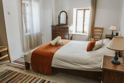 a bedroom with a bed with two pillows on it at Charming 3-Bedroom Cottage in Heart of Vasa Koilaniou in Vasa Kilaniou
