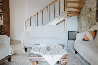 a living room with a couch and a table at Charming 3-Bedroom Cottage in Heart of Vasa Koilaniou in Vasa Kilaniou