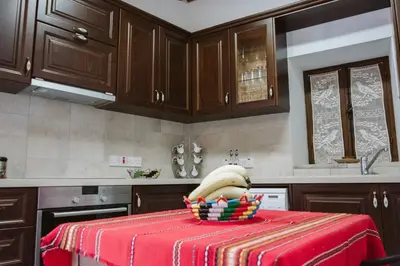 a kitchen with a table with a bowl of bananas on it at Charming 3-Bedroom Cottage in Heart of Vasa Koilaniou in Vasa Kilaniou