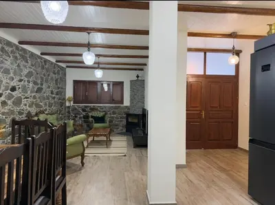 a living room with a stone wall at To Petrino 2 Apartment -Authentic Comfort in the Heart of Kalopanayiotis in Kalopanayiotis