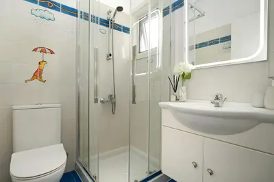 a bathroom with a shower and a toilet and a sink at Villa Amy - 100m from Nisia Loumbardi Beach in Protaras