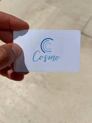a hand holding a white card with the word osuna at Fall In Paradise in Paralimni