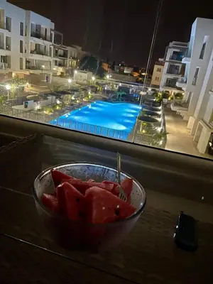 a bowl of fruit sitting on a table next to a window at Fall In Paradise in Paralimni