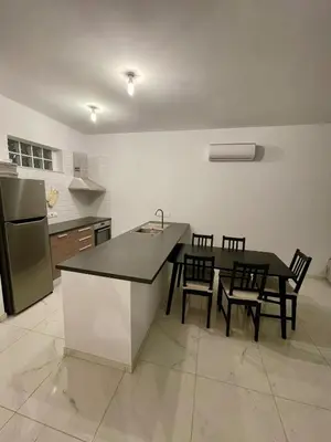 a kitchen with a table and chairs and a refrigerator at Fall In Paradise in Paralimni